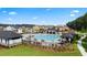 Aerial view of the community pool with lounge chairs and tables, next to other neighborhood amenities at 315 Silver Moon Dr, Loganville, GA 30052
