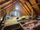 Unfinished attic shows wood beams and insulation at 5668 Blanchard Pl, Sugar Hill, GA 30518