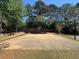 Outdoor community basketball court with basketball hoop and a wooded perimeter at 5668 Blanchard Pl, Sugar Hill, GA 30518