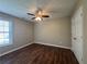 Bedroom showcasing hardwood floors, a ceiling fan, and natural light at 5668 Blanchard Pl, Sugar Hill, GA 30518