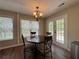 Bright breakfast nook featuring an octagonal table, French doors, and views of the landscaped backyard at 5668 Blanchard Pl, Sugar Hill, GA 30518