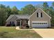 Charming single-Gathering home featuring a well-manicured lawn and attached two-car garage at 5668 Blanchard Pl, Sugar Hill, GA 30518