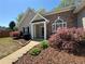 Charming home entrance with well-maintained landscaping and brick accents at 5668 Blanchard Pl, Sugar Hill, GA 30518