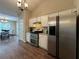 Eat-in kitchen boasts stainless steel refrigerator, gas range, and plenty of storage space with access to dining at 5668 Blanchard Pl, Sugar Hill, GA 30518