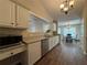 Well-appointed kitchen featuring stainless steel dishwasher, microwave, and access to dining area at 5668 Blanchard Pl, Sugar Hill, GA 30518