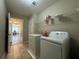 Laundry room with tile floors and shelving at 5668 Blanchard Pl, Sugar Hill, GA 30518