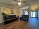 Open-concept living room with high ceilings, recessed lighting, and hardwood floors, adjacent to kitchen at 5668 Blanchard Pl, Sugar Hill, GA 30518