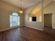 Spacious living room with hardwood floors, vaulted ceiling, and natural light at 5668 Blanchard Pl, Sugar Hill, GA 30518