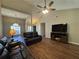 Inviting living room with vaulted ceiling, ceiling fan, and wood-look floors, perfect for relaxing and entertaining at 5668 Blanchard Pl, Sugar Hill, GA 30518