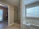 Bright bathroom featuring a glass enclosed shower, a soaking tub, tile floors, and large vanity at 5668 Blanchard Pl, Sugar Hill, GA 30518