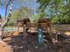 Community wooden playground area with a slide, climbing wall and swing set at 5668 Blanchard Pl, Sugar Hill, GA 30518