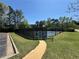 Community tennis court fenced in with a bench nearby and a walking path leading to it at 5668 Blanchard Pl, Sugar Hill, GA 30518