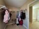 Spacious walk-in closet with metal shelving and doorway view to adjacent bathroom at 5668 Blanchard Pl, Sugar Hill, GA 30518
