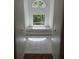 Bright bathroom with a sunken tub below large sunlit windows at 9290 Prestwick Club Dr, Johns Creek, GA 30097