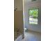 Bathroom with combination shower/tub and large window overlooking yard at 9290 Prestwick Club Dr, Johns Creek, GA 30097