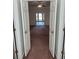 View through open doors to bedroom with ceiling fan and view to the outside at 9290 Prestwick Club Dr, Johns Creek, GA 30097