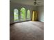 Bedroom with large windows providing natural light, complemented by neutral walls at 9290 Prestwick Club Dr, Johns Creek, GA 30097