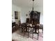 Dining room featuring dark wood table, chandelier and decorative rug at 9290 Prestwick Club Dr, Johns Creek, GA 30097
