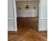 Entryway leading into dining room with wainscoting and hardwood floors at 9290 Prestwick Club Dr, Johns Creek, GA 30097