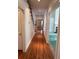 Hallway with hardwood floors leads to rooms with view of staircase at 9290 Prestwick Club Dr, Johns Creek, GA 30097