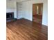 Open living room features built-in shelves, fireplace, and hardwood floors at 9290 Prestwick Club Dr, Johns Creek, GA 30097