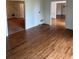 Spacious living room featuring gleaming hardwood floors and connecting doorways at 9290 Prestwick Club Dr, Johns Creek, GA 30097