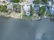 Lakeside home featuring a pool, lush landscaping, and serene water views at 140 N Lakeside Nw Dr, Kennesaw, GA 30144
