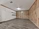 Finished basement area with wood paneling, floating shelves, and wood-look flooring at 140 N Lakeside Nw Dr, Kennesaw, GA 30144