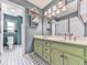 Bathroom featuring a double vanity, decorative mirrors, and a view into the toilet area at 140 N Lakeside Nw Dr, Kennesaw, GA 30144