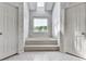 Marble-style bathroom area with a soaking tub, skylight, and two access doors at 140 N Lakeside Nw Dr, Kennesaw, GA 30144