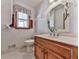 Bathroom with a vanity, mirror, and a patterned wallpaper design at 140 N Lakeside Nw Dr, Kennesaw, GA 30144