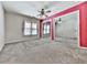 Bedroom featuring a large closet with mirrored doors, a ceiling fan and neutral carpet at 140 N Lakeside Nw Dr, Kennesaw, GA 30144