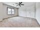 Spacious bedroom with neutral carpet, a ceiling fan, and a double door closet at 140 N Lakeside Nw Dr, Kennesaw, GA 30144