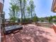 Outdoor deck with hot tub overlooks a serene lake view, offering a relaxing space at 140 N Lakeside Nw Dr, Kennesaw, GA 30144