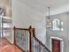 Foyer view of staircase with decorative railing and light fixture at 140 N Lakeside Nw Dr, Kennesaw, GA 30144
