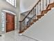 Elegant foyer featuring decorative glass sidelights, a wood door, and staircase with wood banister at 140 N Lakeside Nw Dr, Kennesaw, GA 30144