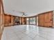 Spacious living room showcasing a stone fireplace, wood-paneled walls, and built-in shelving and lighting at 140 N Lakeside Nw Dr, Kennesaw, GA 30144