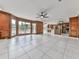 Open-concept living room and kitchen featuring windows with a backyard view and tile flooring at 140 N Lakeside Nw Dr, Kennesaw, GA 30144