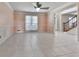 Living room with tile floor, ceiling fan, and large window at 140 N Lakeside Nw Dr, Kennesaw, GA 30144