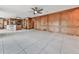 Open concept living area with kitchen, wood paneling, tile floors, and access to a large outdoor deck at 140 N Lakeside Nw Dr, Kennesaw, GA 30144