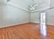 Spacious main bedroom with hardwood floors and ceiling fan, leading to an attached bathroom at 140 N Lakeside Nw Dr, Kennesaw, GA 30144