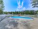 Inviting in-ground pool with a concrete surround, loungers, and a protective fence, perfect for summer relaxation at 140 N Lakeside Nw Dr, Kennesaw, GA 30144