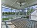 Screened porch boasts lake views, a wooden deck, and a ceiling fan for comfortable outdoor living at 140 N Lakeside Nw Dr, Kennesaw, GA 30144