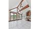 Bright sunroom with high ceilings, exposed beams, and large windows offering scenic lake views at 140 N Lakeside Nw Dr, Kennesaw, GA 30144