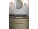 Stylish bathroom featuring a granite countertop, modern vanity and decorative round mirror at 1490 N Crossing Circle Ne Cir # 1490, Atlanta, GA 30329