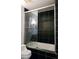 Contemporary bathroom boasts black tiled walls, sleek glass enclosed shower-tub, and modern toilet at 1490 N Crossing Circle Ne Cir # 1490, Atlanta, GA 30329
