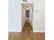 Hallway with hardwood floors leading to brick wall with neutral paint and white trim at 1490 N Crossing Circle Ne Cir # 1490, Atlanta, GA 30329
