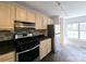Kitchen featuring stainless steel appliances, tile backsplash, and light wood cabinetry with natural light at 1490 N Crossing Circle Ne Cir # 1490, Atlanta, GA 30329