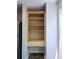 Wooden shelving storage and drawer unit next to stainless refrigerator and matching backsplash at 1490 N Crossing Circle Ne Cir # 1490, Atlanta, GA 30329