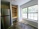 Bright kitchen nook with large window, stainless fridge, and built-in shelving for ample storage at 1490 N Crossing Circle Ne Cir # 1490, Atlanta, GA 30329